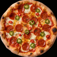 A pizza coming out of the oven on South Main